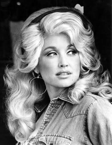 Black-and-white portrait of Dolly Parton in a denim shirt