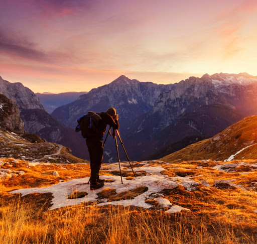Photographer capturing an Alpine sunset